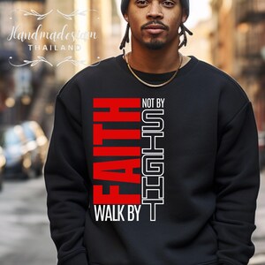 May include: Black sweatshirt with a red and white graphic that says "FAITH WALK BY NOT BY SIGHT".