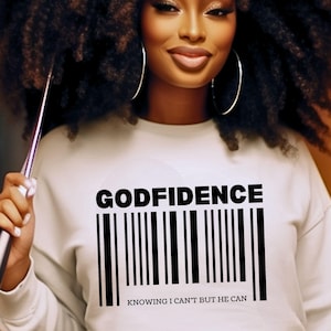 May include: White sweatshirt with black text that reads "GODFIDENCE" and a barcode underneath. The text below the barcode reads "KNOWING I CAN'T BUT HE CAN".