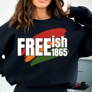 May include: Black sweatshirt with a white graphic that says "FREE 1865" with a red, orange, and green brushstroke design.