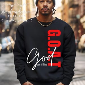 May include: Black sweatshirt with red text that reads "G.O.A.T. God over all things" in a cursive font.