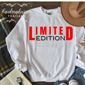 May include: White sweatshirt with the text "LIMITED EDITION" in red and black letters.