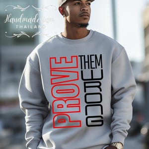 May include: A gray sweatshirt with the words "PROVE THEM WRONG" printed in red and black.