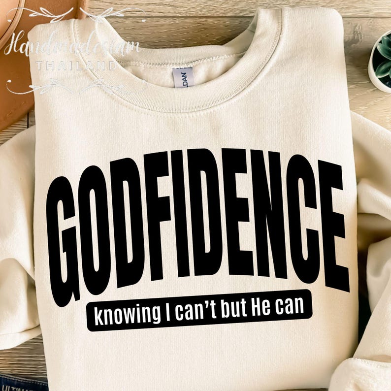May include: A cream colored sweatshirt with the text "GODFIDENCE knowing I can't but He can" in black lettering.