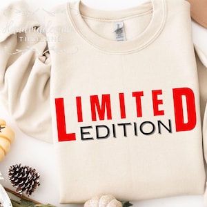 May include: A beige sweatshirt with the text "LIMITED EDITION" in red and black letters.