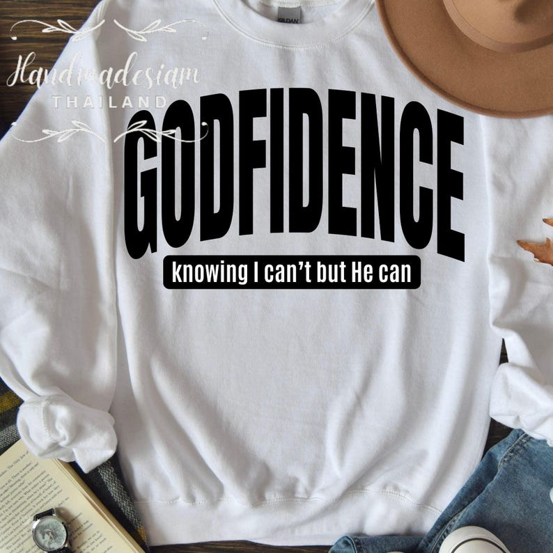 May include: White sweatshirt with black text that reads "GODFIDENCE knowing I can't but He can".