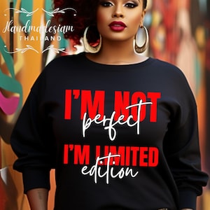 May include: Black sweatshirt with the text "I'M NOT perfect I'M LIMITED edition" in red and white. The sweatshirt is part of a clothing line. The brand name "Handmadesiam THAILAND" is in the upper left corner.