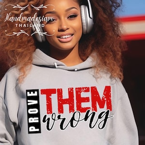 May include: A gray hoodie with the text "PROVE THEM WRONG" in red and black lettering. The text is in a distressed font style.