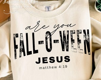 May include: Cream-colored sweatshirt with the text "are you FALL-O-WEEN JESUS" in black, with "matthew 4:19" below. The sweatshirt is a crew neck style.