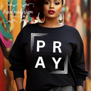 May include: Black sweatshirt with a white graphic that says "PRAY" in a box.