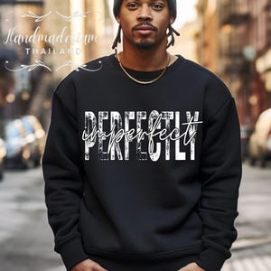 May include: Black sweatshirt with a white graphic that says "Perfectly Imperfect".