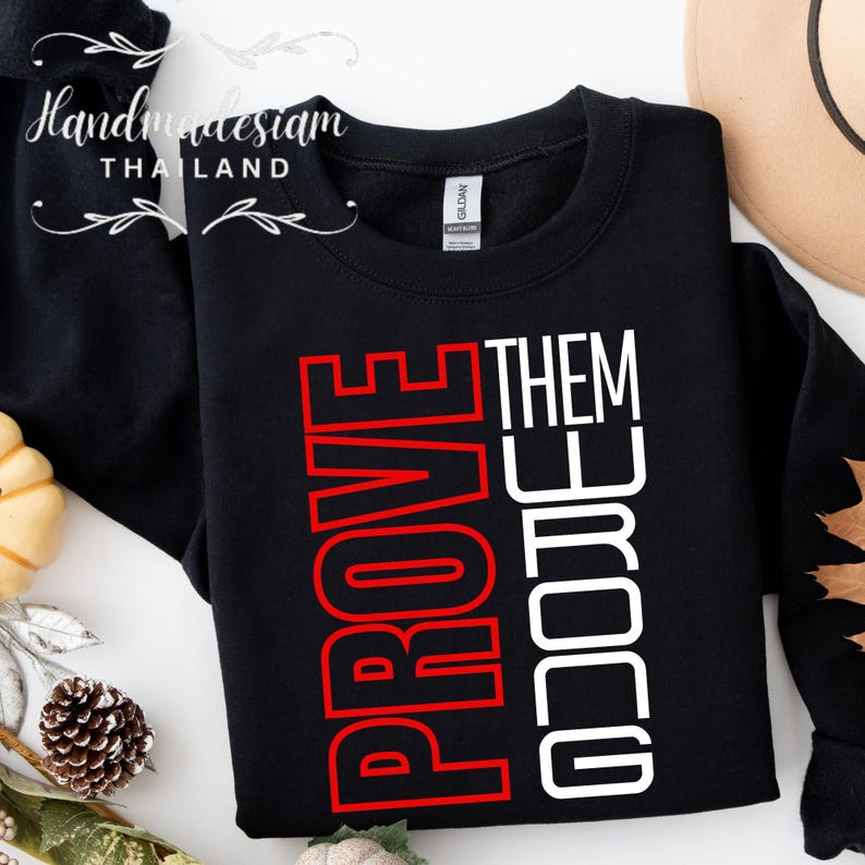 May include: Black sweatshirt with white text that reads "GO GET THEM" and red text that reads "PROVE" in a vertical design.