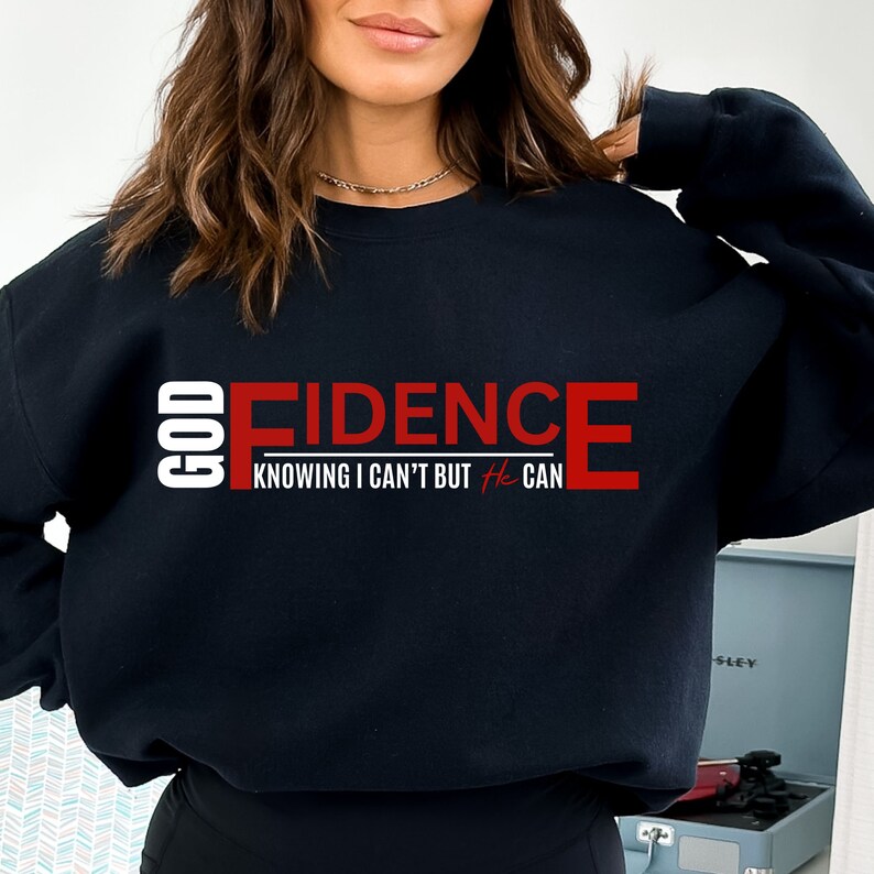 May include: Black sweatshirt with the text "GOD FIDENCE KNOWING I CAN'T BUT HE CAN" in red and white lettering.