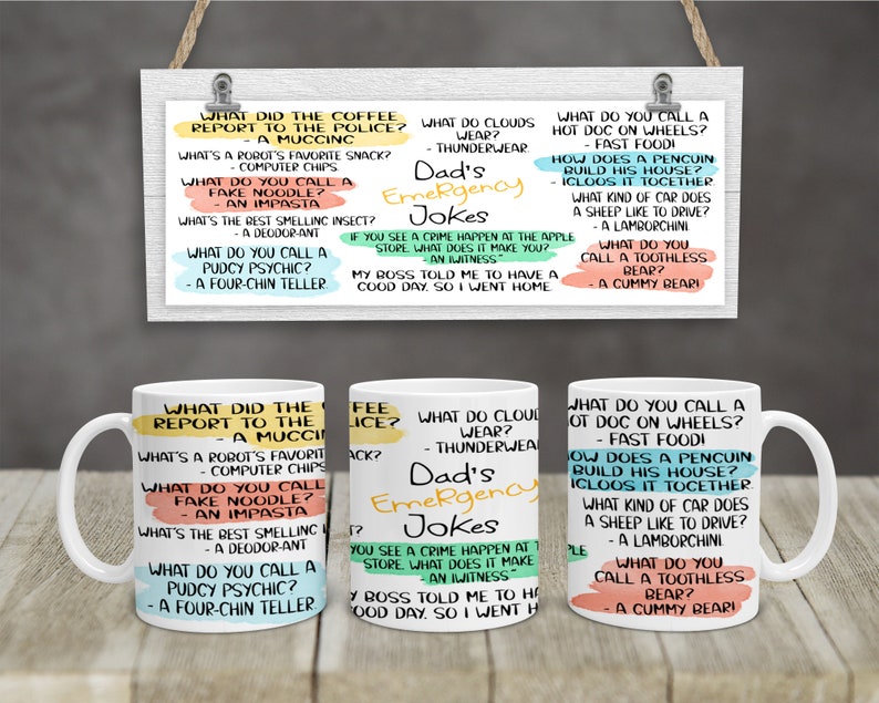 May include: Two white ceramic mugs with black handles. Each mug features a different set of dad jokes printed in colourful text. The text on the mugs includes questions and answers about a variety of topics, such as food, animals, and everyday life.