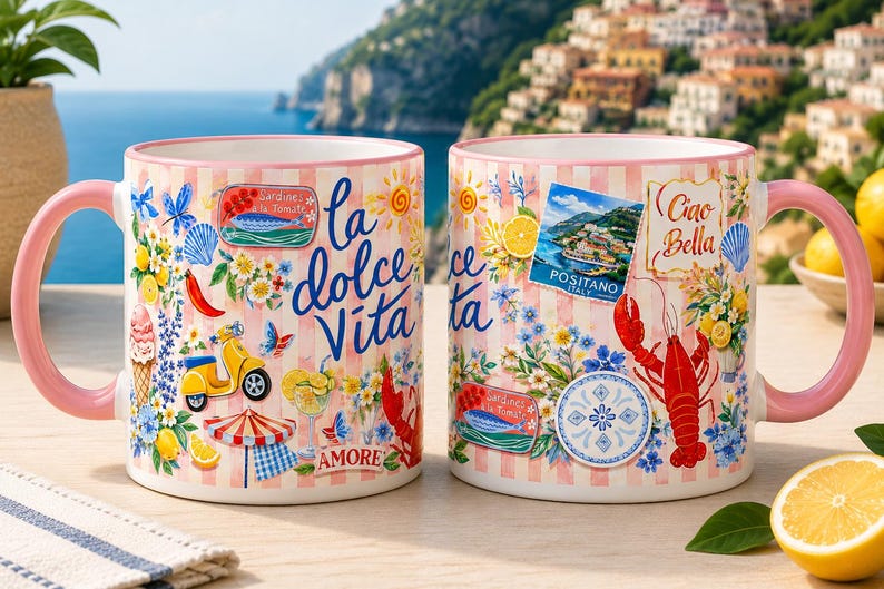 May include: Two ceramic mugs with pink handles and a design featuring Italian imagery. The mugs have a pink and white striped background with illustrations of lemons, flowers, a scooter, and the words "la dolce Vita" and "Ciao Bella".