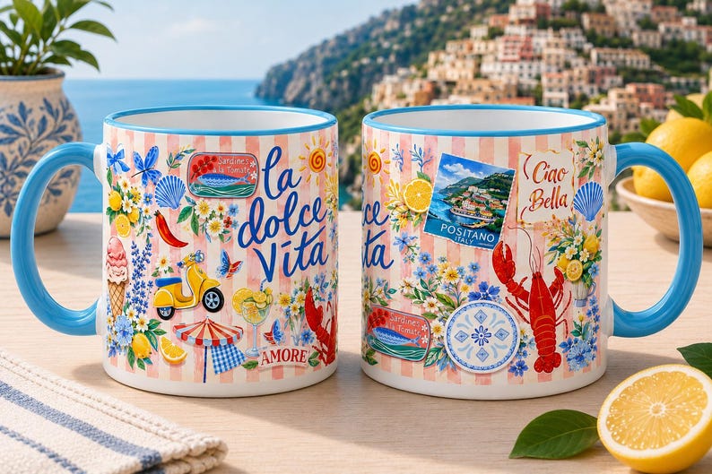 May include: Two ceramic mugs with blue handles and rims. The mugs feature a design with Italian imagery, including a yellow scooter, lobster, and the words "la dolce Vita" and "Ciao Bella". The background is a light pink and white striped pattern.
