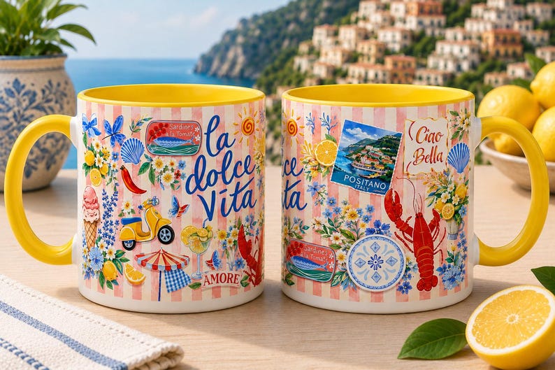 May include: Two ceramic mugs with yellow handles and interiors. The mugs feature a design with Italian imagery, including a lobster, scooter, and the words "La Dolce Vita" and "Ciao Bella". The background has a pink and white striped pattern.