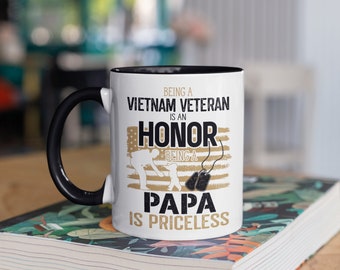 May include: White ceramic coffee mug with a black rim and handle. The mug features a graphic of a soldier saluting a child with the text "Being a Vietnam Veteran is an Honor. Being a Papa is Priceless."
