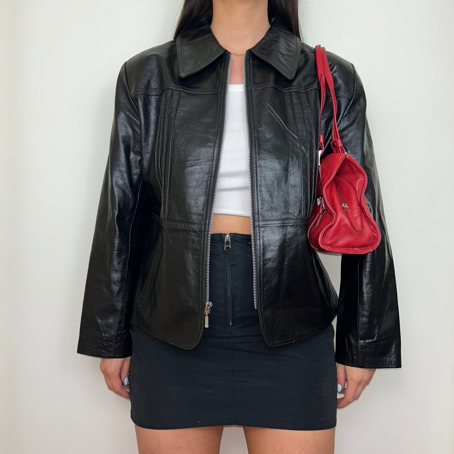 Vintage real leather shiny bomber zip up jacket with zipper closure and two front pockets.