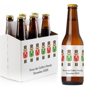 May include: A six-pack of beer with a white cardboard carrier featuring a repeating pattern of nutcracker soldiers. The beer bottles have labels with a similar nutcracker soldier pattern and the text "From the Collin's Family December 20XX".