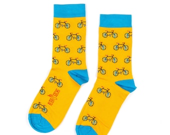 May include: A pair of yellow socks with a repeating pattern of bicycles in blue and red. The socks have blue cuffs and toes. The text "ALTER SOCKS" is printed on the side of one sock.