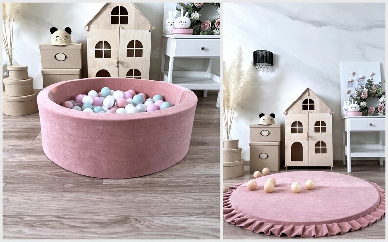 May include: A pink velvet ball pit with a ruffled edge, filled with pastel colored balls. The pit is in a room with a wooden dollhouse and other decor.
