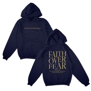 May include: Navy blue hoodie with a large white "FAITH OVER FEAR" graphic on the front and a smaller white "FAITH OVER FEAR" graphic on the back with the text "PSALMS 118:6 The Lord is on my side, I will not fear. What can man do unto me?"