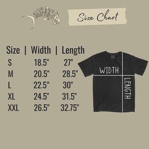 May include: A black t-shirt with a size chart. The chart shows measurements for width and length in inches for sizes S through XXL. The shirt's width ranges from 18.5" to 26.5", and the length ranges from 27" to 32.75".