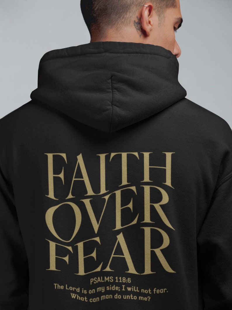 May include: Black hoodie with the words "FAITH OVER FEAR" in gold lettering on the back. The text "PSALMS 118:6" is below the words, followed by the quote "The Lord is on my side: I will not fear. What can man do unto me?"