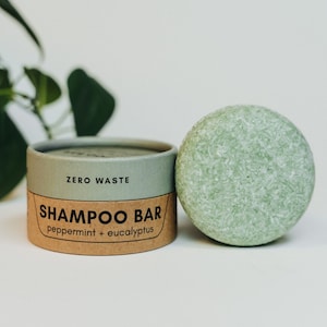 May include: A green shampoo bar in a cardboard container with the text "ZERO WASTE SHAMPOO BAR peppermint + eucalyptus".