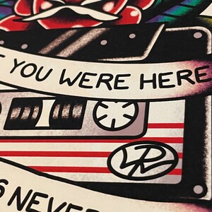 May include: A vintage-style cassette tape with a red, white, and blue design. The tape has a rose and a banner that reads "Like you were here, this never ending..."