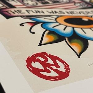 May include: A red and white illustration of a cassette tape with the text "While you were out the fun was never over" and a flower with a yellow eye. The image is framed and has a red stamp in the lower right corner.