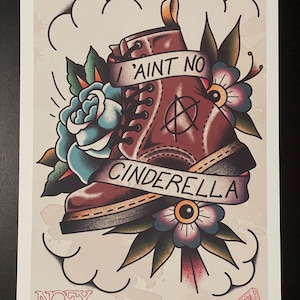 May include: A vintage-style tattoo illustration of a brown leather boot with a black anarchy symbol and a banner that reads "I ain't no Cinderella". The boot is surrounded by blue and purple flowers and green leaves. The text "NOFX" is in the bottom left corner.