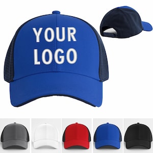May include: A blue trucker hat with the text "YOUR LOGO" in white. The hat has a mesh back and a curved brim. Additional hats in gray, white, red, blue, and black are shown below.