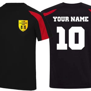 May include: Black and red athletic jersey with the text "YOUR NAME" and the number "10" in white. The jersey has a yellow crest with text and a logo. The sleeves have red accents.