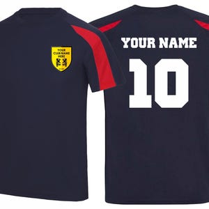 May include: Navy blue athletic jersey with red shoulder accents. The front features a yellow crest with text and a logo. The back displays the text "YOUR NAME" above the number "10" in white.