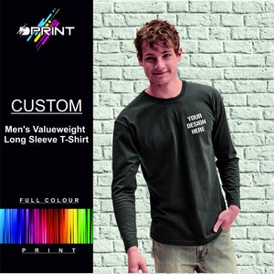 May include: A dark green long-sleeved t-shirt with the text "YOUR DESIGN HERE" printed on the front. The t-shirt is made from a soft, comfortable fabric and is ideal for everyday wear.