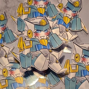 May include: A collection of die-cut stickers featuring a stylised robot character with white, blue, and yellow armour. The robot has a blushing face, blue eyes, and a circular yellow emblem with a small heart on each side of its head.