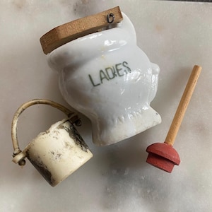 May include: A rustic wooden sign with the text "Welcome to our home" in white lettering. The sign features a distressed finish and a simple, inviting design, perfect for front door decor.
