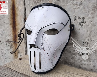 May include: White leather mask with a black strap and red paint splatters. The mask has a large, open mouth with a metal grill and a small, pointed nose.