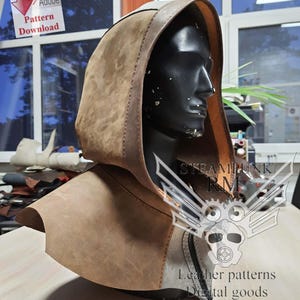 May include: A brown leather hooded cowl with a stitched seam detail. The cowl is displayed on a mannequin head. The image includes the text "Steampunk RM" and "Leather patterns Digital goods".