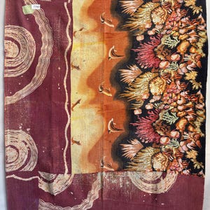 May include: A patchwork quilt with a burgundy background and a variety of colorful patterns, including a coral reef scene and a swirling design. The quilt has a tag with the number 7790.