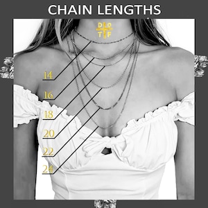 May include: A grayscale image showcasing a woman wearing multiple silver necklaces of varying lengths. The image includes text indicating chain lengths from 14 to 24 inches. The necklaces are displayed against a white top.