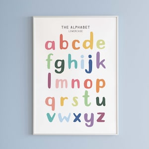 May include: A white poster with a black frame featuring the lowercase alphabet in colorful, handwritten letters. The title "THE ALPHABET" and "LOWERCASE" are printed in black at the top of the poster.