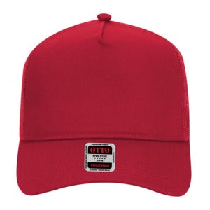 May include: A red trucker hat with a mesh back and a snap closure. The hat features a classic fit and a small rectangular tag with the text "OTTO" and "TRUCKER".