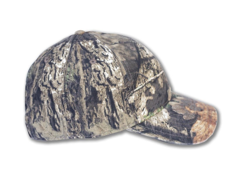 May include: A camouflage baseball cap with a curved brim. The cap features a pattern of brown, green, and tan, resembling tree bark. The cap is designed for outdoor activities.
