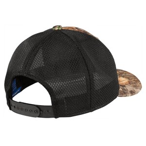 May include: A black and camouflage baseball cap with a mesh back. The cap has a black adjustable strap with a plastic buckle.