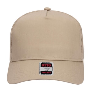 May include: A tan trucker hat with a mesh back and a curved brim. The hat features a snap closure and a small rectangular label with the text "OTTO TRUCKER" and "CLASSIC MESH BACK".