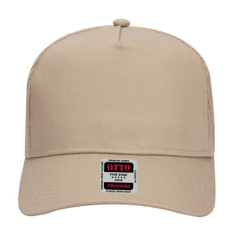 May include: A tan trucker hat with a mesh back and a curved brim. The hat features a snap closure and a small rectangular label with the text "OTTO TRUCKER" and "CLASSIC MESH BACK".