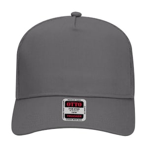May include: A gray trucker hat with a mesh back and a curved brim. The hat features a snap closure and a small tag with the brand name "OTTO" and the text "FIVE STAR OSFM TRUCKER CLASSIC MESH BACK".