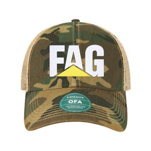 May include: A camouflage trucker hat with a white "FAG" logo and a yellow triangle. The hat has a brown mesh back and a green label that reads "Legacy OFA Visor Boards Made From Recycled Content Live Your Legacy".